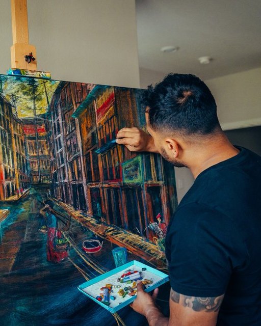 Kushal Bastakoti painting a cityscape in the studio